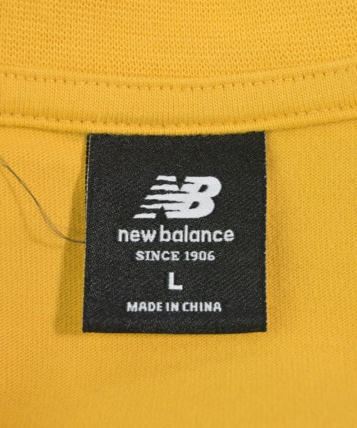 New Balance เสื้อยืด/เสื้อท็อปส์