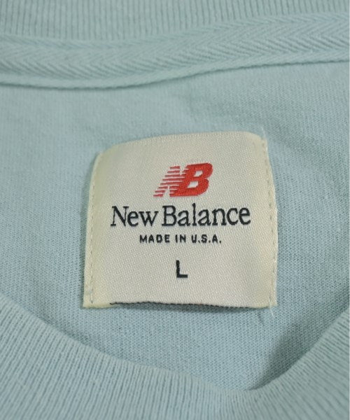 New Balance เสื้อยืด/เสื้อท็อปส์